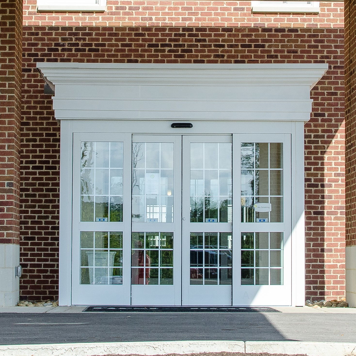 Photo of a new automatic sliding door in a brick building