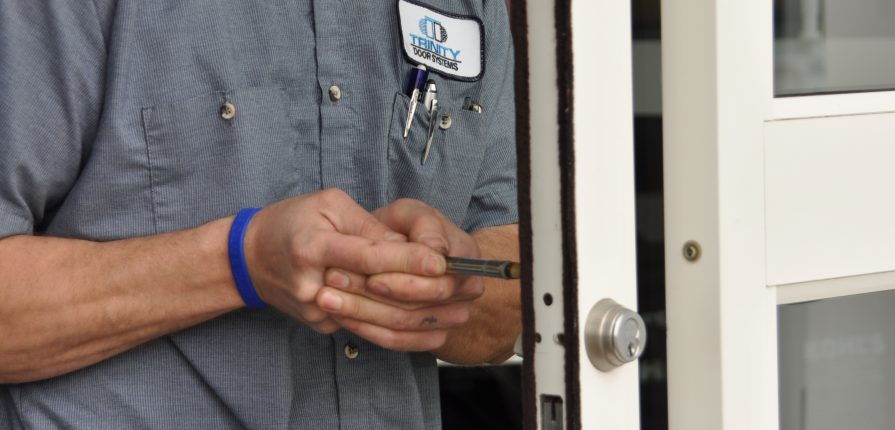 Photo of a door technician working on an automatic door