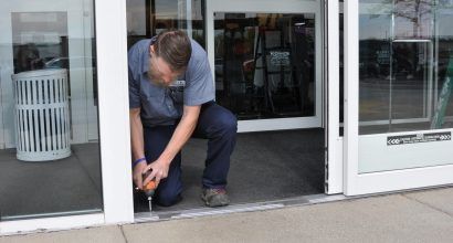 Photo of a door technician working on a door threshold