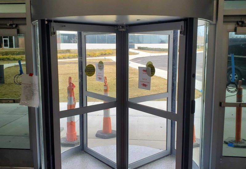 Photo of an automatic revolving door being installed in a building