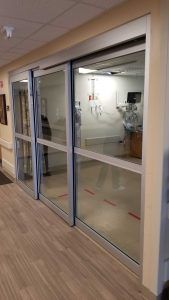 Photo of a large manual sliding door in a medical facility