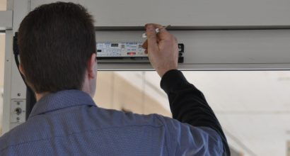 Photo of a door technician adjusting a safety sensor